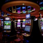 Vibrant casino floor with colorful slot machines and bright lights capturing a lively gaming atmosphere.